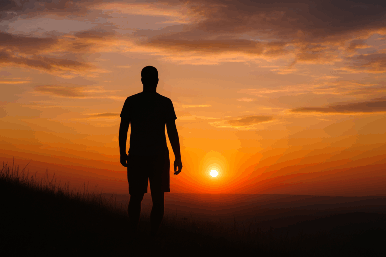 夕暮れの空を背景に丘の上に立つ男性のシルエット、人生の失いと感謝を象徴する情景